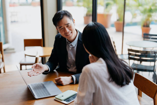 Insurance agent having discussion with client in cafe